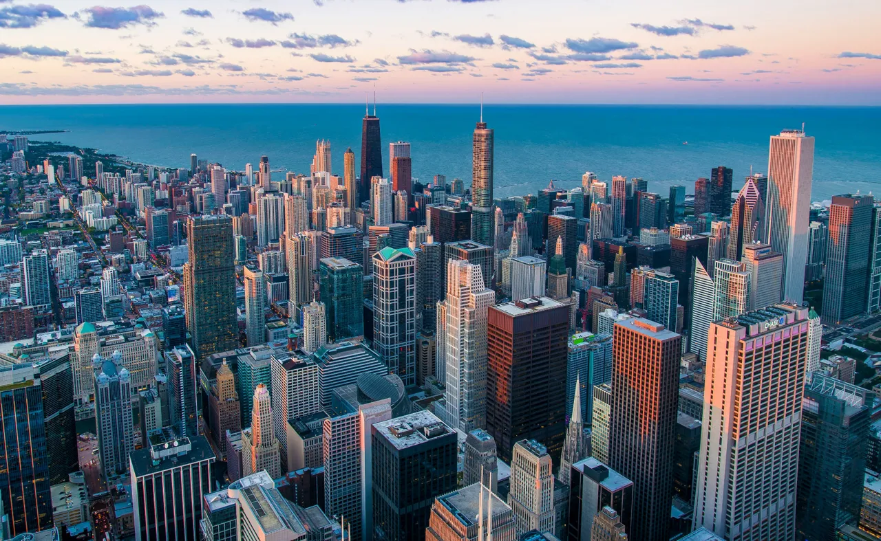 Chicago skyline from above, with Lake Michigan at dusk